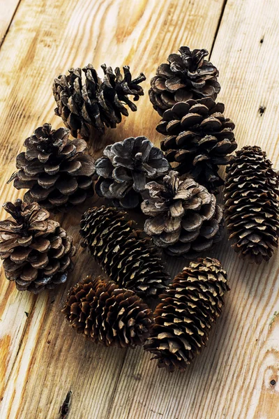 Pine cones on wooden background Royalty Free Stock Photos