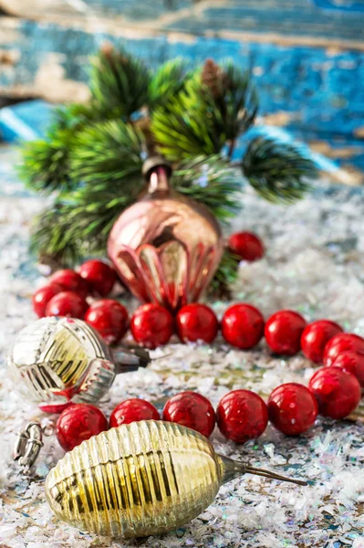 Coral beads on light blue background covered in snow — Stock Photo, Image