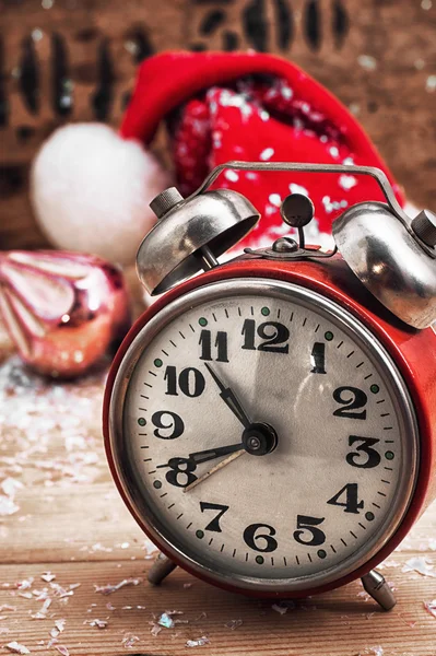 Old-fashioned alarm clock and red Christmas cap — Stock Photo, Image