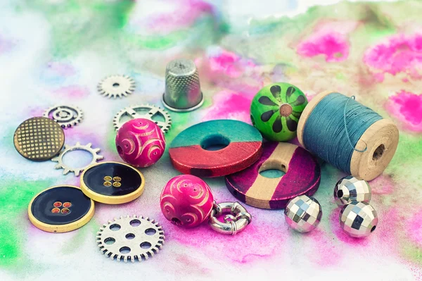 Threads and embellishments on a colorful background — 图库照片