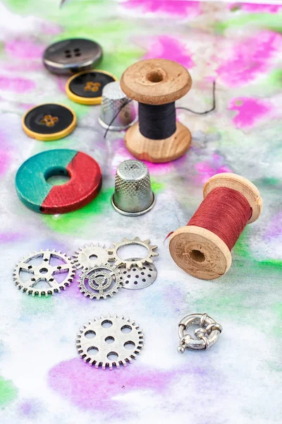 Threads and embellishments on a colorful background — Stock fotografie