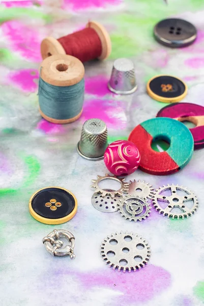 Threads and embellishments on a colorful background — Stock fotografie