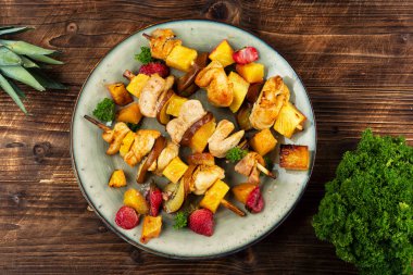 Platter of grilled meat skewers featuring vibrant and juicy pineapple