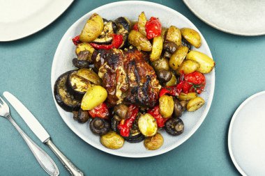 A whole piece of meat baked with different vegetables.