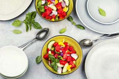 A refreshing watermelon and cucumber salad, fresh summer salad. Flat lay