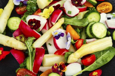 Beyaz kuşkonmaz salatası, salatalık, domates ve yenilebilir çiçekler..