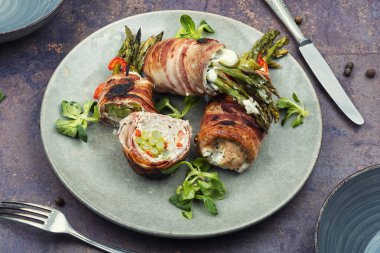 Cooked asparagus served with meat on a plate. Savory meal prepared with fresh ingredients, food photography.