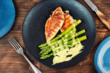 Tabakta etle servis edilen kuşkonmaz. Taze malzemeler ve yemek fotoğraflarıyla hazırlanmış tuzlu bir yemek..