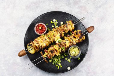 Dilimlenmiş patates ve pastırma şiş şeklinde..