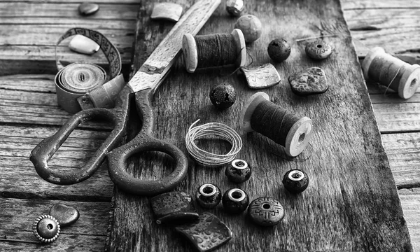 Tools and jewelry for needlework on wooden background — Stock Photo, Image