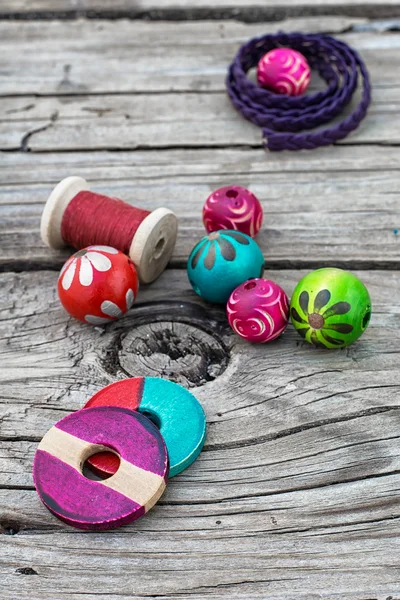 Beads on wooden background — Stock Photo, Image