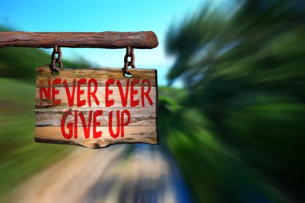 Never ever give up motivational phrase sign — Stock Photo, Image