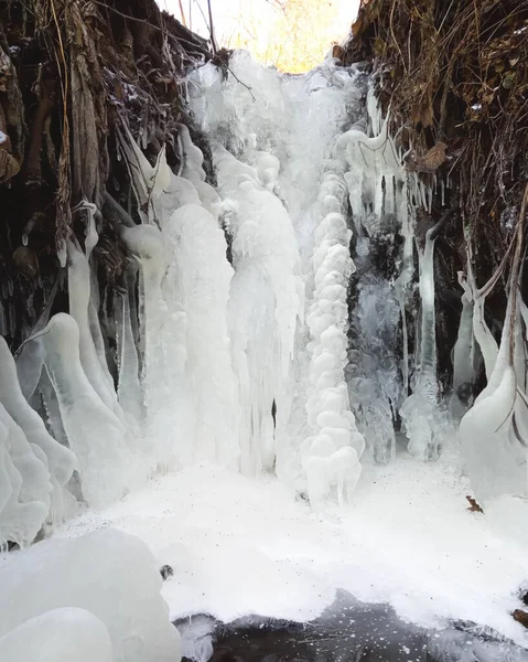 frozen waterfall, frozen stream in winter