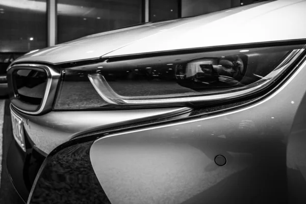 BERLIN - NOVEMBER 28, 2014: Showroom. A fragment of the car BMW i8, first introduced as the BMW Concept Vision Efficient Dynamics, is a plug-in hybrid sports car developed by BMW. Black and white. — Stock Photo, Image