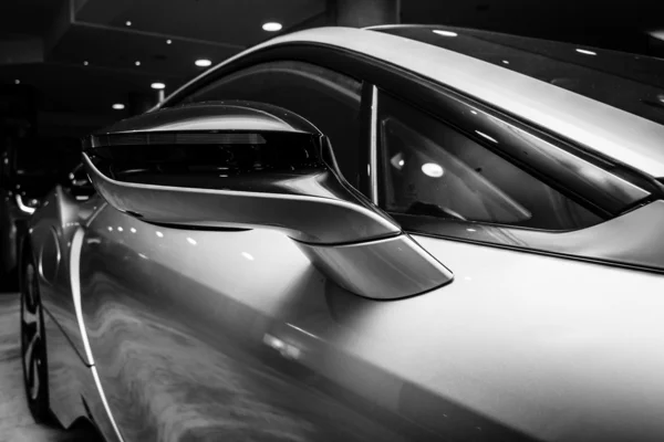 BERLIN - NOVEMBER 28, 2014: Showroom. A fragment of the car BMW i8, first introduced as the BMW Concept Vision Efficient Dynamics, is a plug-in hybrid sports car developed by BMW. Black and white. — Stock Photo, Image