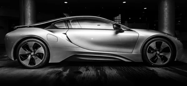 BERLIN - NOVEMBER 28, 2014: Showroom. The BMW i8, first introduced as the BMW Concept Vision Efficient Dynamics, is a plug-in hybrid sports car developed by BMW. Black and white. — Stock Photo, Image