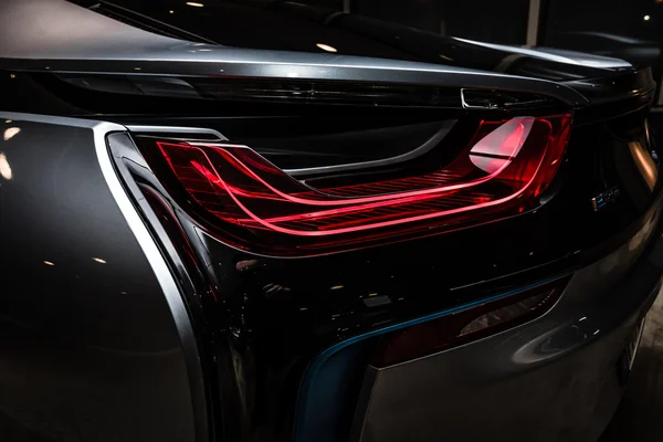 BERLIN - NOVEMBER 28, 2014: Showroom. The rear lights of the car BMW i8, first introduced as the BMW Concept Vision Efficient Dynamics, is a plug-in hybrid sports car developed by BMW. Toning — Stock Photo, Image