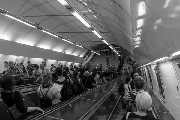 Prague metro. Passengers on the escalator. Black and white. Prague is the capital and largest city of the Czech Republic. — Stock Photo, Image