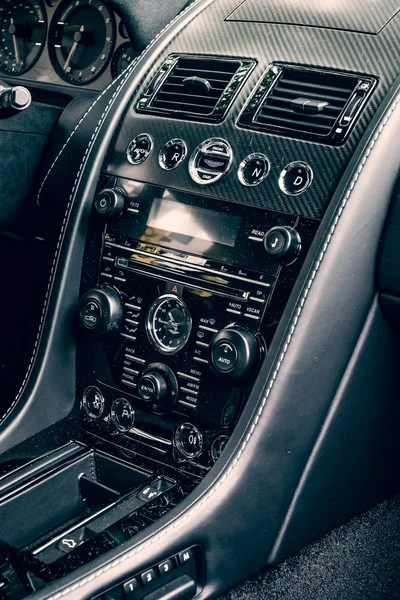 Fragment of the dashboard of a luxury sports car Aston Martin V8 Vantage N430 (since 2015). Toning. Stylization. The Classic Days on Kurfuerstendamm. — Stock Fotó