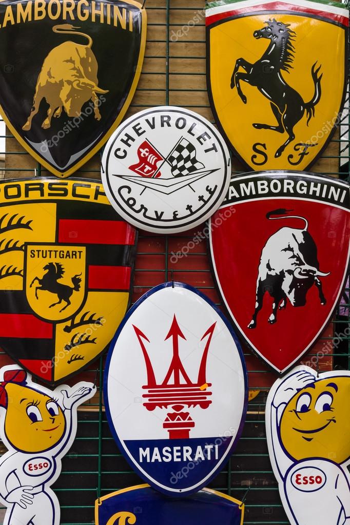 BERLIN - JUNE 14, 2015: Background of various emblems of various car brands producing sports cars. The Classic Days on Kurfuerstendamm.