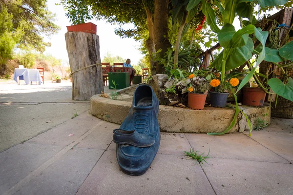 A giant and miniature rubber overshoes. Vignetting. — Stock Photo, Image