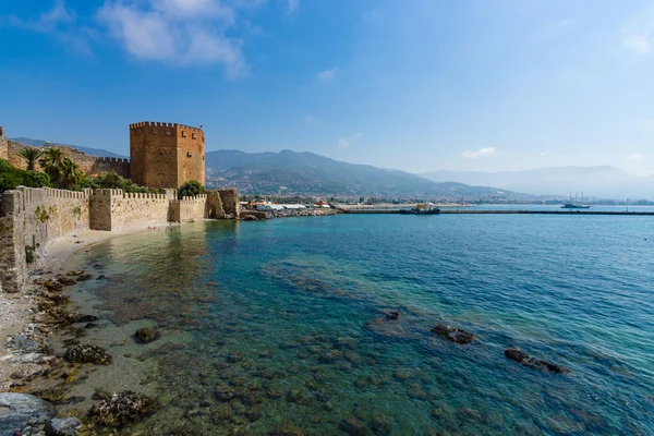 Torre Rossa (Kizil Kule) e le rovine del muro della fortezza vicino alla riva. La costa mediterranea. Alanya. Turchia — Foto Stock