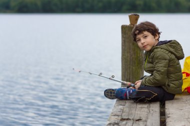 Young boy fishing. clipart