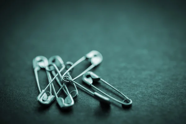 Safety pin on a dark. — Stock Photo, Image