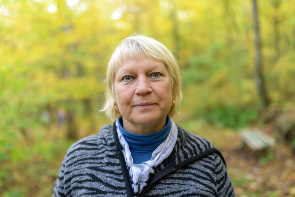 Portrait of a beautiful middle-aged woman in the park.