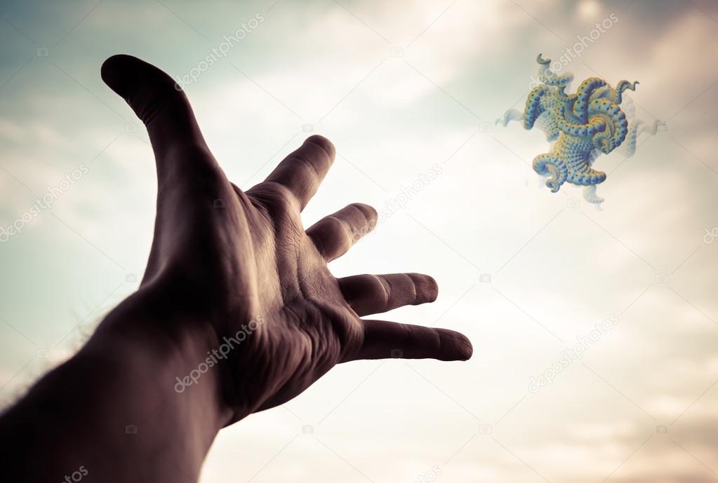 Hand reaching to the fractal figure.