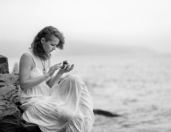 Portrait of a woman holding zen stones.