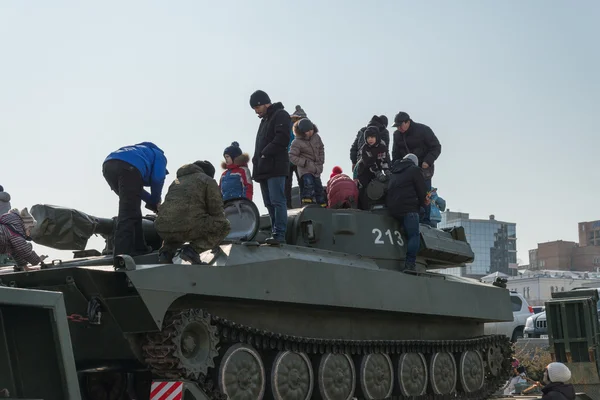 Los niños juegan en el moderno vehículo blindado ruso . — Foto de Stock