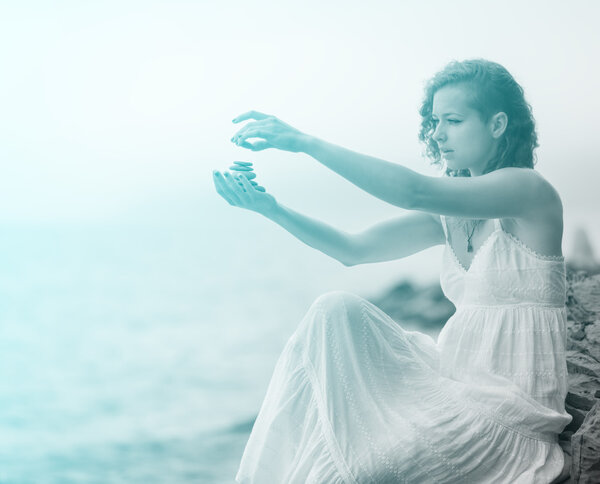 Portrait of woman holding zen stones.