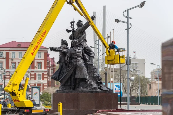 Workers wash the monument.