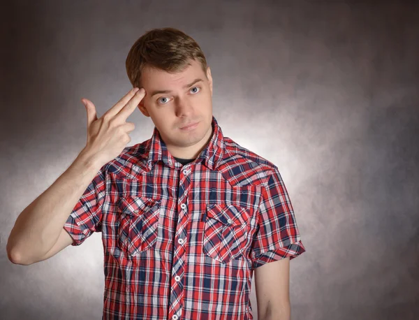 Man shows headshot with his fingers. — Stock Photo, Image