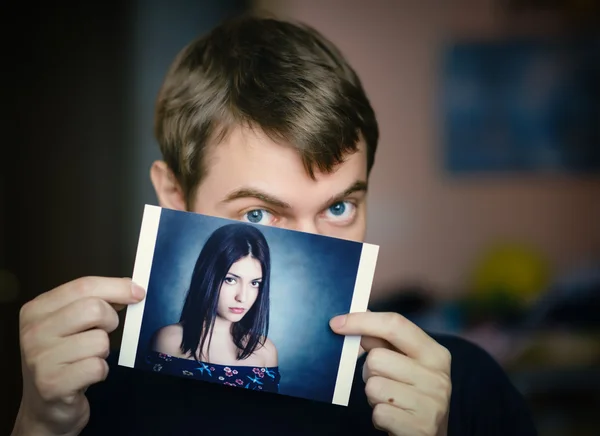 Homem segurando uma foto de uma menina . — Fotografia de Stock