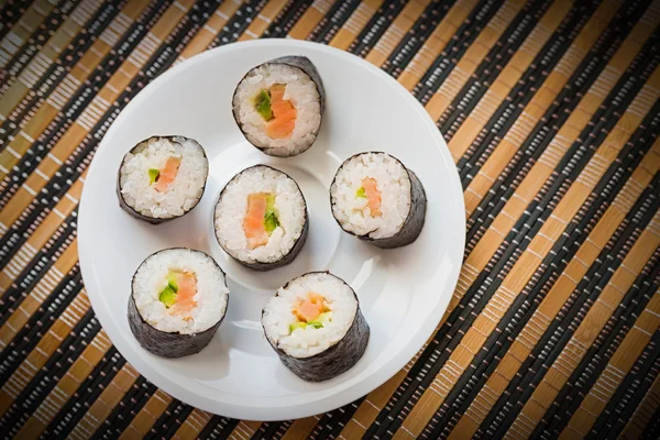 Rolls with salmon in white dish. — Stock Photo, Image