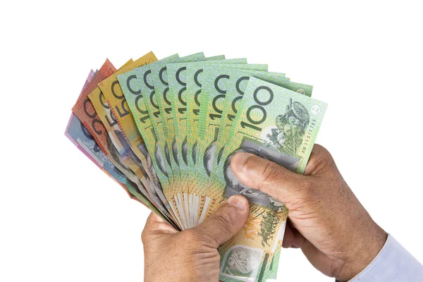 Ellenőrzés, vagy a számolás ausztrál dollárt a kezében az ember. — Stock Fotó
