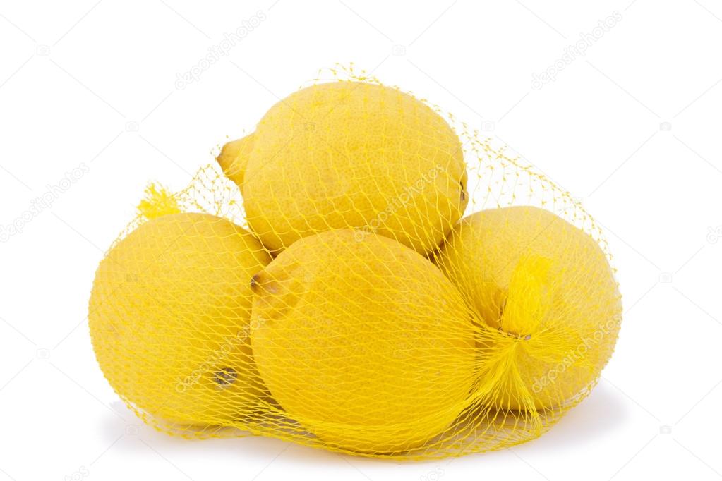 Ripe lemons in a net bag on a white background.