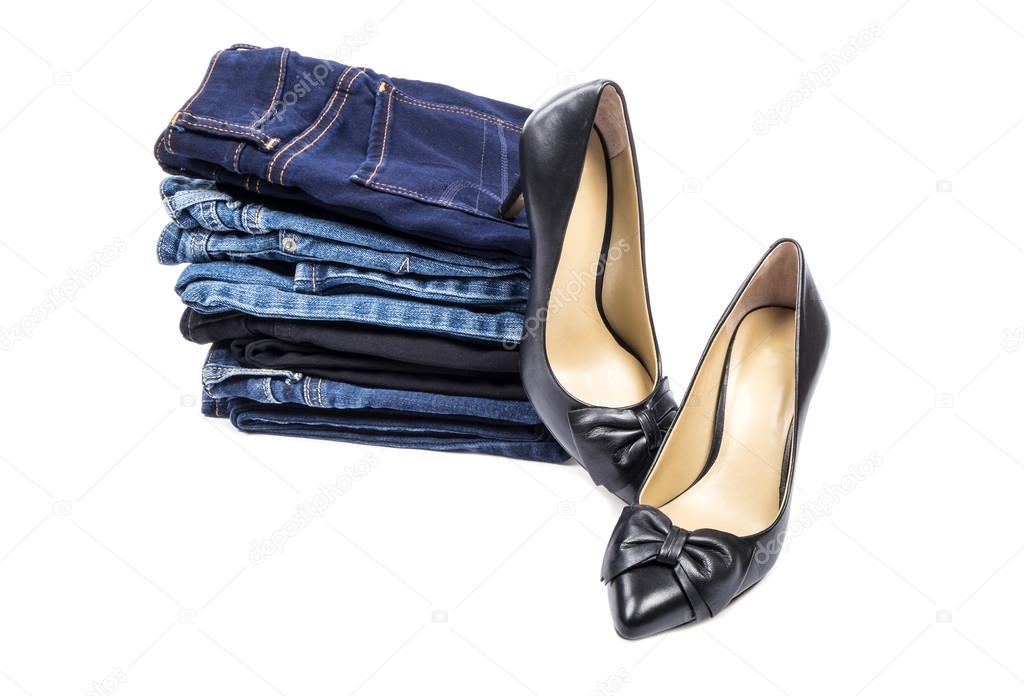 Stack of Blue Jeans and Black Leather High Heel Shoes