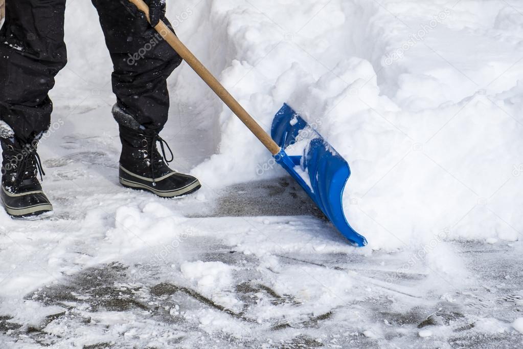 Man Removing Snow with a Shovel