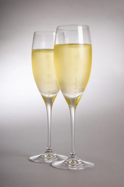 Dos copas de champán sobre fondo gris — Foto de Stock