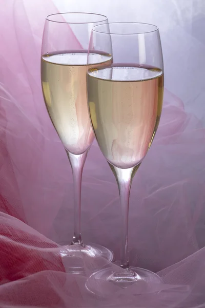 Two Glasses of Champagne with Backlit Tulle Background — Stock Photo, Image