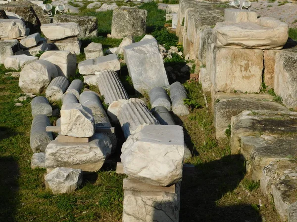 Marble column pieces and stones outside the Parthenon, on the Acropolis, in Athens, Greece