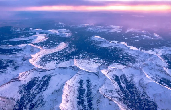 stock image flying over rockies in airplane from salt lake city at sunset