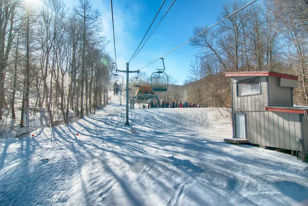 Ski lift with seats going over the mountain — Stock Photo, Image