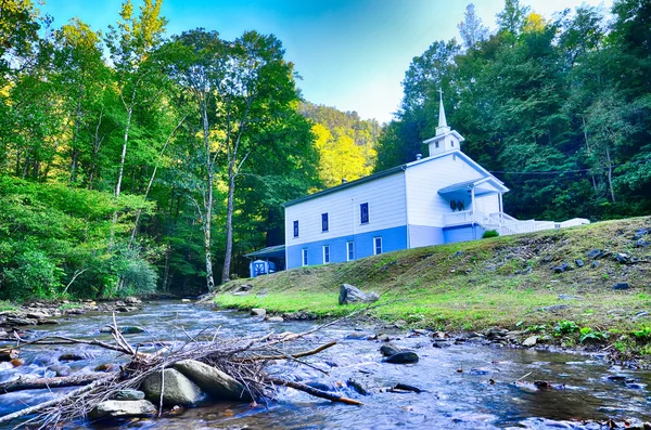 Igreja nas montanhas junto ao rio — Fotografia de Stock
