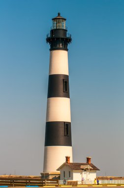 Black and white striped lighthouse at Bodie Island on the outer  clipart