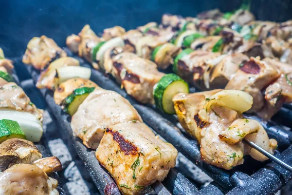 Shish kebab on skewers on a grill on a holiday — Stock Photo, Image