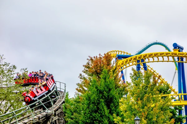 Locos paseos en montaña rusa en el parque de atracciones — Foto de Stock